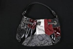 lot 45 image: Bebe Patchwork Handbag - Multi-Color Panels, Grommet Accent, Top Handle