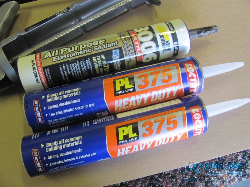 lot 27 image: Three Caulking Guns with two (2) NEW cans of ...
