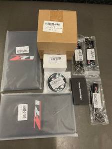 lot 38 image: GMC Z71 Accessories Kit - Leather Car Accessories, Cup Holder Clips, Valve Caps