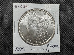 lot 3 image: 1885 Morgan Silver Dollar Marked MS 63 when purchased
