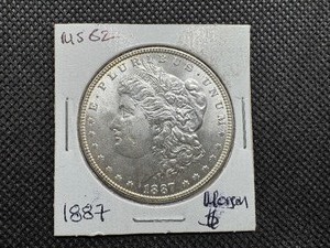 lot 5 image: 1887 Morgan Silver Dollar Marked MS 62 when purchased