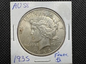 lot 14 image: 1935 Peace Silver Dollar Marked AU58 when purchased