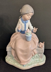lot 22 image: K - Nao by LLADRO Porcelain Figurine - Girl in Tan Skirt on Garden Bench