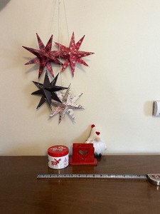 lot 87 image: 4-Piece Hanging Star Ornaments - Red Plaid, Red Speckled, Black, White Text