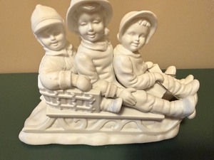lot 153 image: Three-Child Sled Figurine