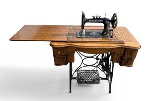lot 7 image: Antique Cast Iron New Home Sewing Machine (Orange, Massachusetts USA) in Original Cabinet