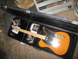 Squire electric guitar in a hardshe...