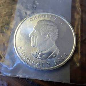lot 134 image: 2024 Canada 1 oz Silver Maple Leaf  BU  Charles III � 5 Dollars � APMEX protective sleeve