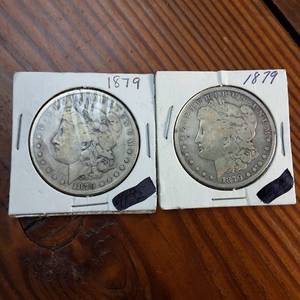 lot 63 image: Lot of 2  1879 Morgan silver dollars  Weight 26.7 grams 90% silver  Popular by the US Mint