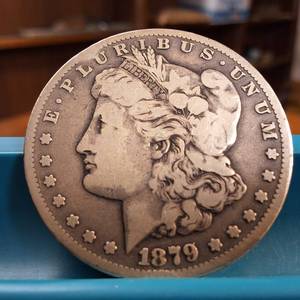 lot 42 image: 1879-S Morgan silver dollar  Weight 26.7 grams 90% silver  Most popular collected coin by the US Mint