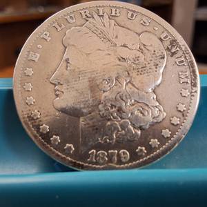 lot 59 image: 1879-S Morgan silver dollar  Weight 26.7 grams 90% silver  Most popular collected coin produced USA