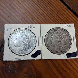 lot 48 image: Lot of 2  1900 Morgan silver dollars  Weight 26.7 grams 90% silver  produced by the US Mint