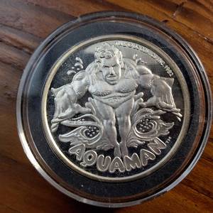lot 101 image: (1987) 1 Troy Ounce .999 Silver Round featuring �AQUAMAN� AMC Mint Cartoon Celebrity Series