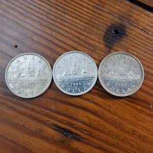 lot 81 image: Lot of 3  1945, 1946 and 1947 Silver Canada Dollars  80% silver  circulated, one is bright