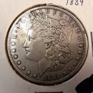 lot 93 image: 1884 Morgan silver dollar  Weight 26.7 grams 90% silver  Most popular by the US Mint