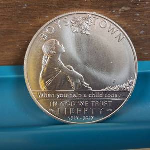 lot 228 image: 2017 Boys Town Centennial Silver Dollar  90% silver and 10% copper, weighs 26.73  38.1 mm.