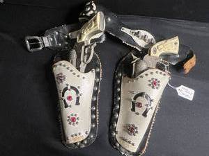 lot 127 image: Gene Autry Cap Guns Pair - Ornate Western Toy Pistols with Ivory Grips & Leather Holsters
