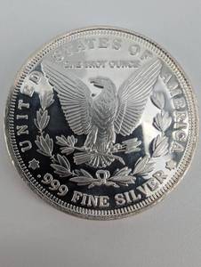 lot 34 image: Morgan 1oz Silver round