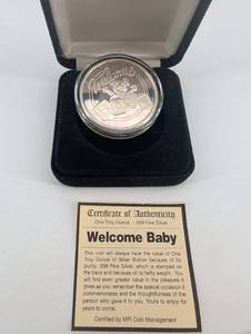 lot 55 image: MPI Welcome Baby 1oz .999 Fine Silver Coin - Certificate Included