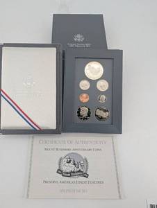 lot 97 image: United States Mint Mount Rushmore Anniversary Silver Dollar & Half Dollar Prestige Set 1991
