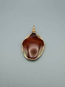 lot 71 image: Gold-Tone Wire-Wrapped Brown Cabochon Pendant 2 x 1 inch