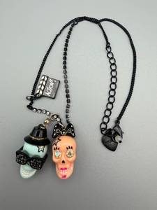 lot 182 image: Betsey Johnson Skull Pendant Necklace - Double Skull Charms on Black Chain with Rhinestone Eyes