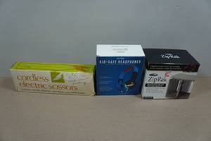 lot 122 image: Cordless Electric Scissors, Kid-Safe Headphones & Zip Rak