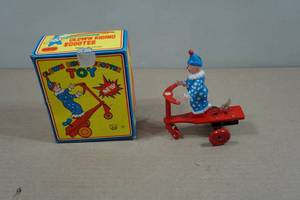 lot 166 image: Vintage Tin Clown on Scooter Wind-Up Toy
