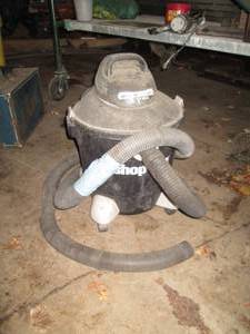 lot 223 image: 12-gallon Shop-Vac with hose shown...