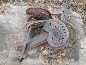 lot 29 image: 9 Antique Cast Iron tractor seats w...