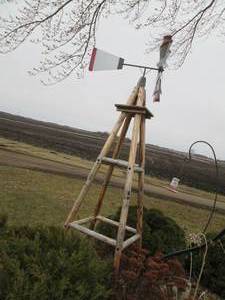 lot 94 image: Windmill on a rustic wood stand...