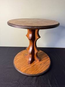 lot 50 image: Oak Round Pedestal End Table with Carved Double-Scroll Base