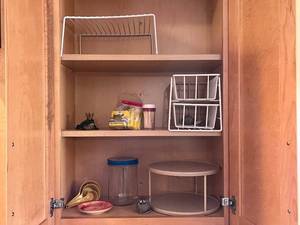 lot 74 image: Kitchen Cabinet Contents - White Wire Racks, Jars, Spoons, Candles & Decor