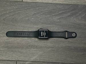 lot 21 image: Apple Watch SE (Model A2351)  40mm GPS-only Smartwatch (Used, ICloud Is Locked. Light Scratches On Face, With Charger)