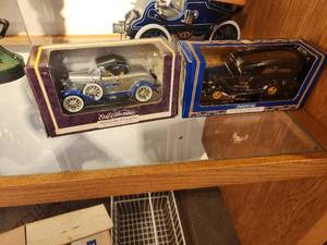 lot 1101 image: Lot of (2) 125 Scale Die-Cast Metal Collectibles - 1930 Ford Roadster Car and 12th Edition 1936 Ford Bank by Ertl Collectibles (in original packaging)