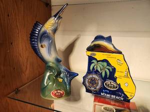 lot 1105 image: Lot of (2) Whisky Decanters - 1974 Erza Brooks Commemorative American Legion 56th National Convention Miami Beach, 1970 Erza Brooks Marlin Sailfish Nautical