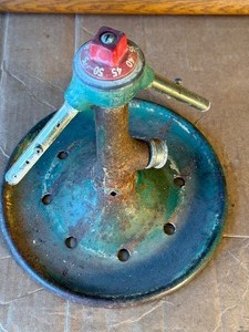 Vintage Rain King lawn sprinkler from the 1920s through the 1950s, manufactured by the Chicago Flexible Shaft Company.