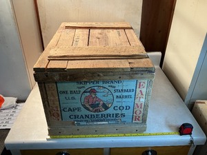 Vintage wooden storage box with contents inside