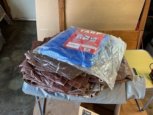 Miscellaneous tarps of various sizes and a cover for car or boat