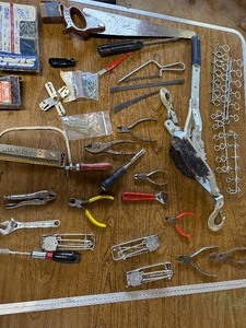 Box of tools including a come along and various hardware ect