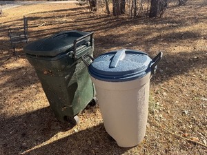 Two Rubbermaid garbage containers