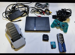 Sony PlayStation 2 Slim console bundle including controllers, cables, and accessories