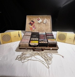 Vintage Bose speaker set with briefcase filled with cassette tapes