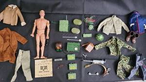 lot 37 image: Vintage G.I. Joe Action Figure Lot with Army Manual, Gear & Clothing