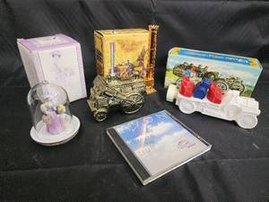lot 58 image: Glass Bell Dome Figurine with Lavender Gown, Antique Train Toys & Avon CD Set