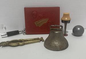lot 40 image: Fun Misc. Items Bell, Nutcracker, Memories Book, Leg Lamp Figurine Flashlight and Metal Ball