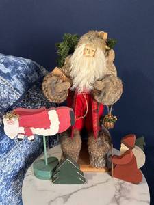 Santa Claus Figurine Display with Wooden Christmas Cutouts