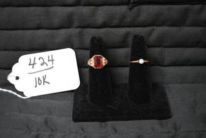 Ladies rings, one with red stone is...