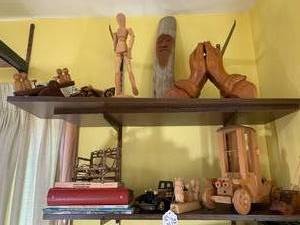 Wood carvings and books, all on 2 s...