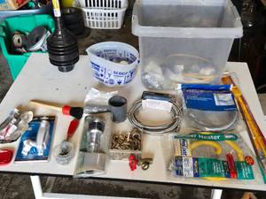 Plumbing and Hardware Tools and Supplies including Washing Machine Hose, Water Heater Connector, and Various Fittings